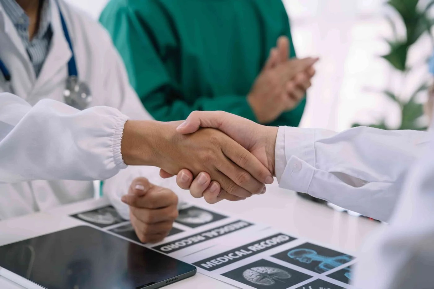 Doctor and nursing assistant meeting with a patient