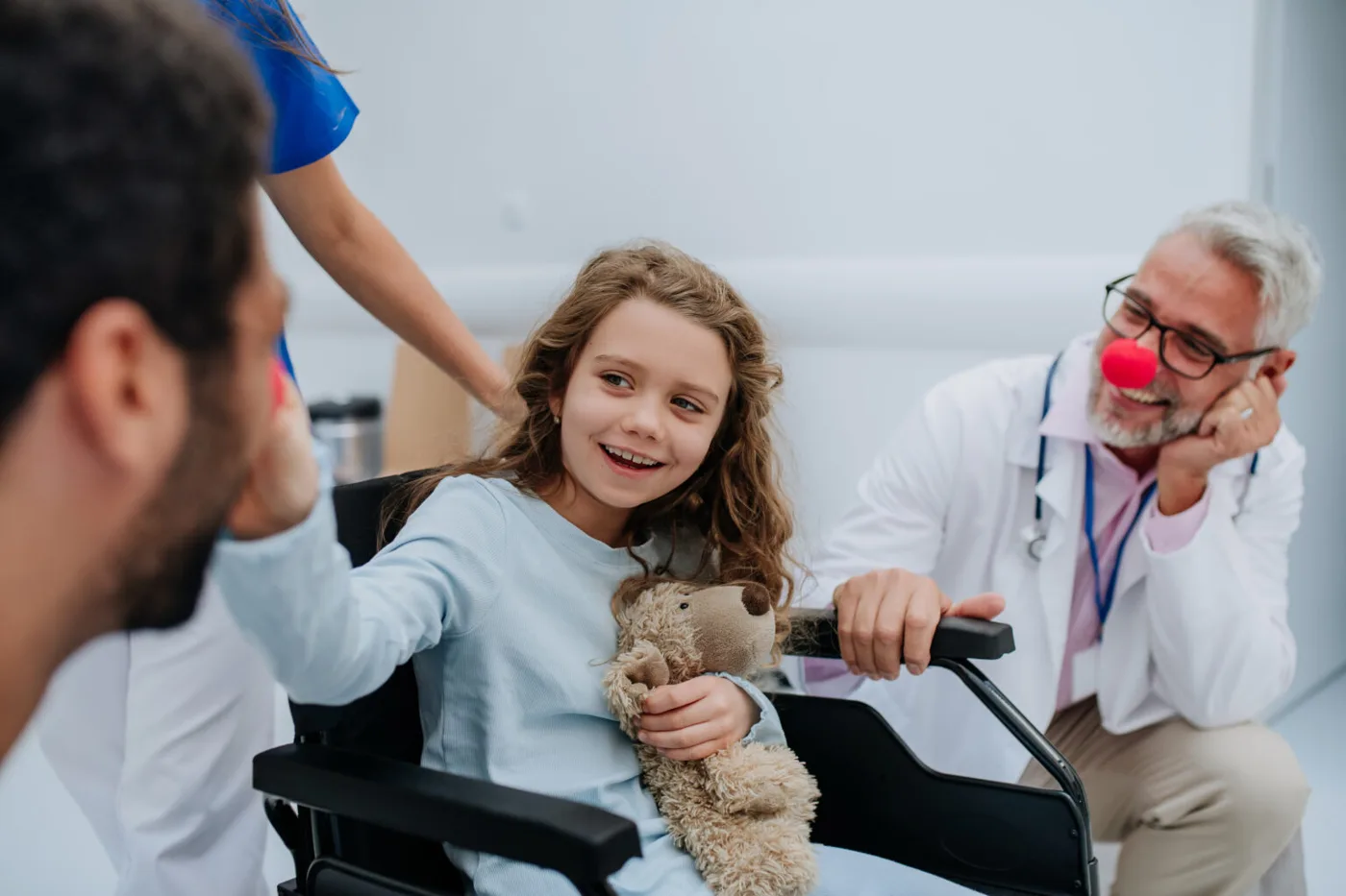Happy care team with a young patient